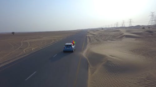 Mini Cooper Traveling Through A Desert