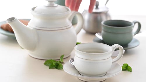 Close up View of a Person Preparing a Cup of Mint Tea