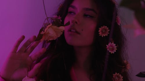 A Female Model Posing with Flowers on her Hair