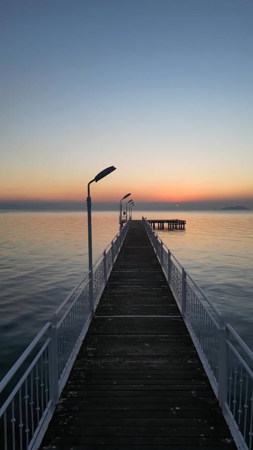 Drone View of a Wooden Pier at Sunset 