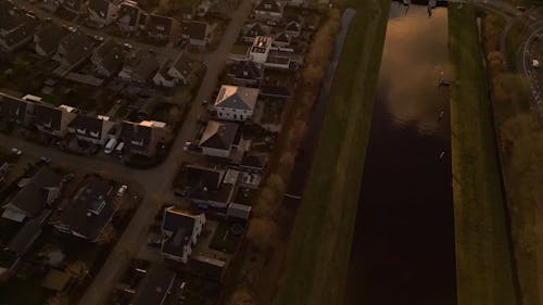 Aerial View of a Residential Area and a Water Canal at Sunset 