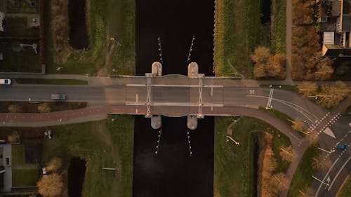 Top View of Vehicles Crossing a Bridge over a Water Canal 