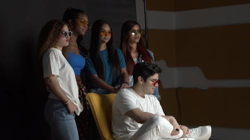 Young People in Tinted Sunglasses Posing during a Photo Session 