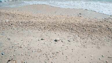 a beach with waves and sand