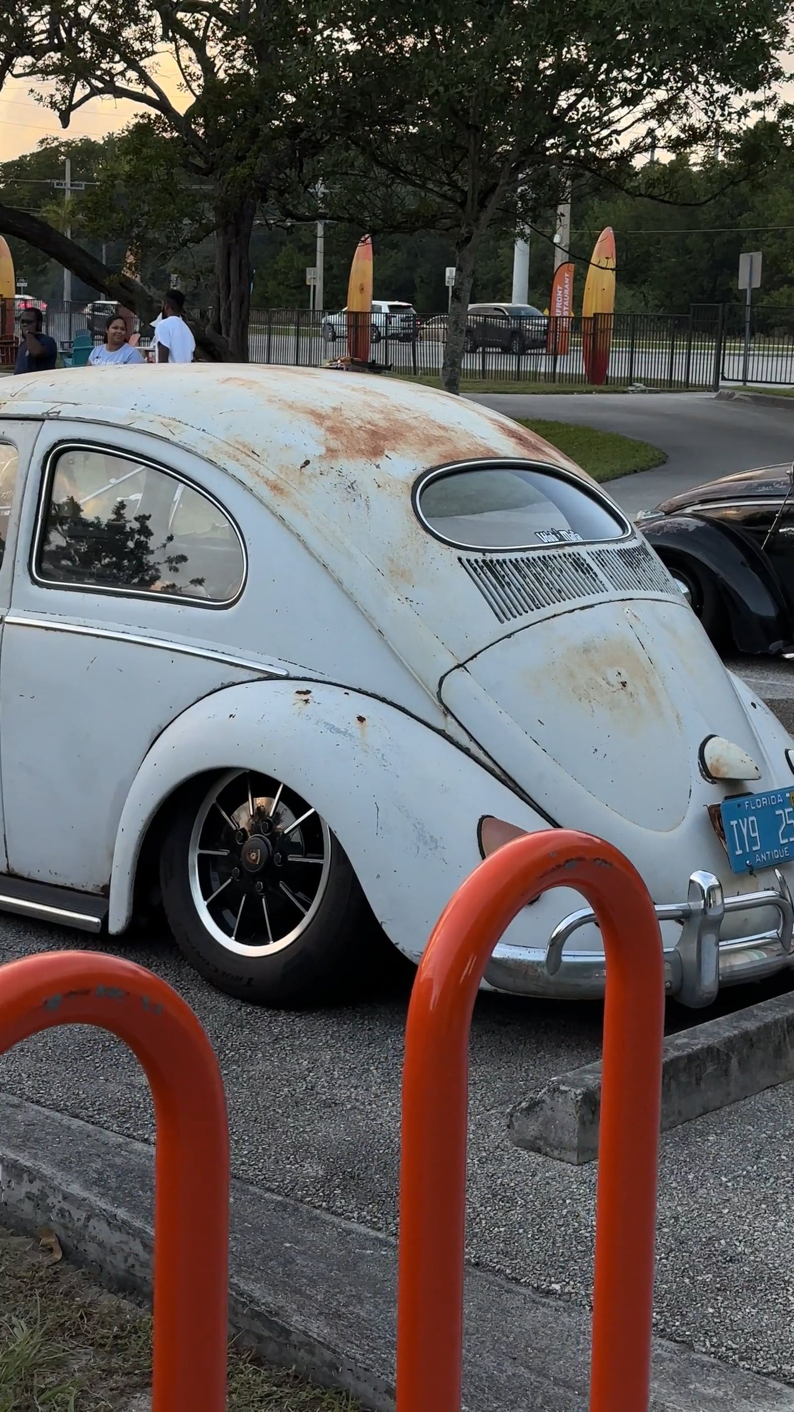 A white volkswagen beetle parked in front of a tent Free Stock Video ...