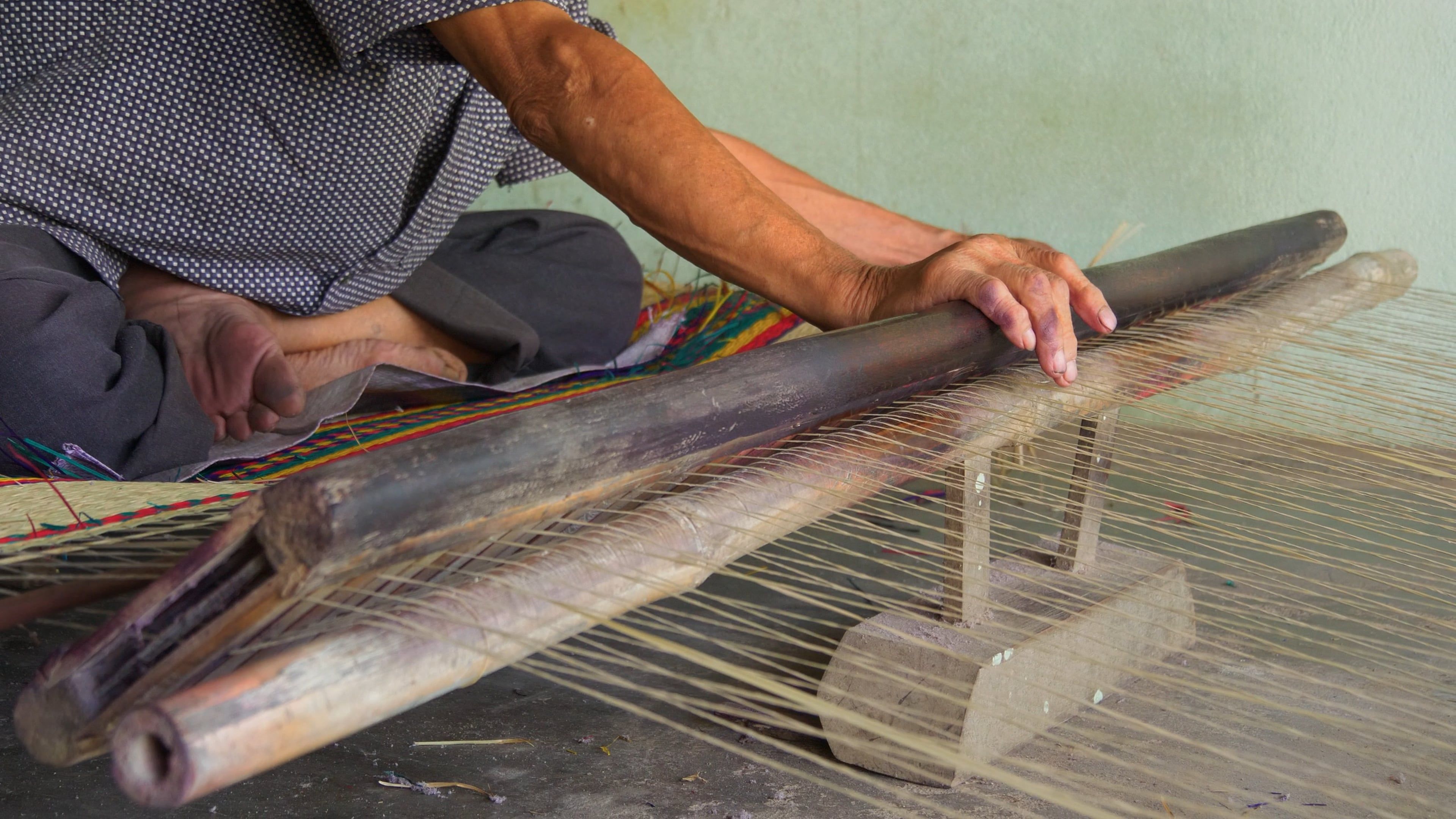A man is weaving a piece of cloth on a loom Free Stock Video Footage ...