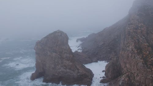 Drone Footage of a Rocky Coast on a Foggy Day
