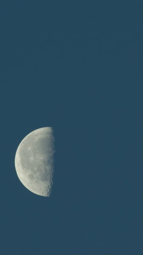 Half moon moving quickly across sky vertical