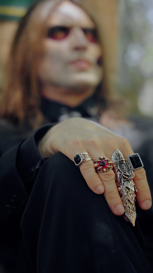 A Man Dressed up as a Zombie Wearing Large Rings 