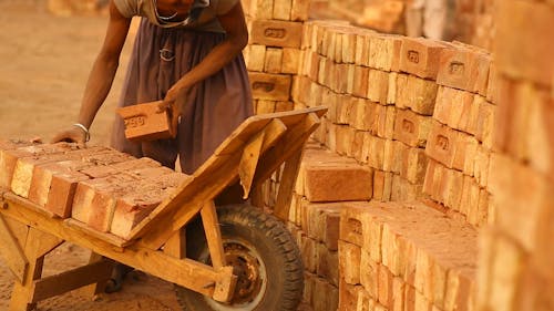 A Young Man Arranging Bricks 
