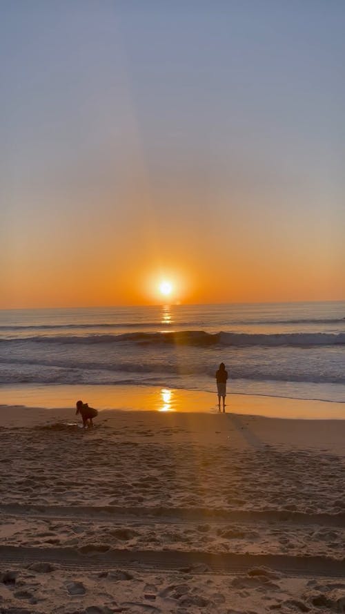 Children Playing on the Beach at Sunset 