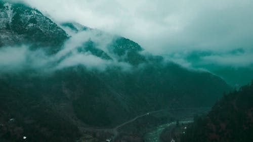 Drone Footage of a Foggy Mountain Landscape on a Rainy Day 