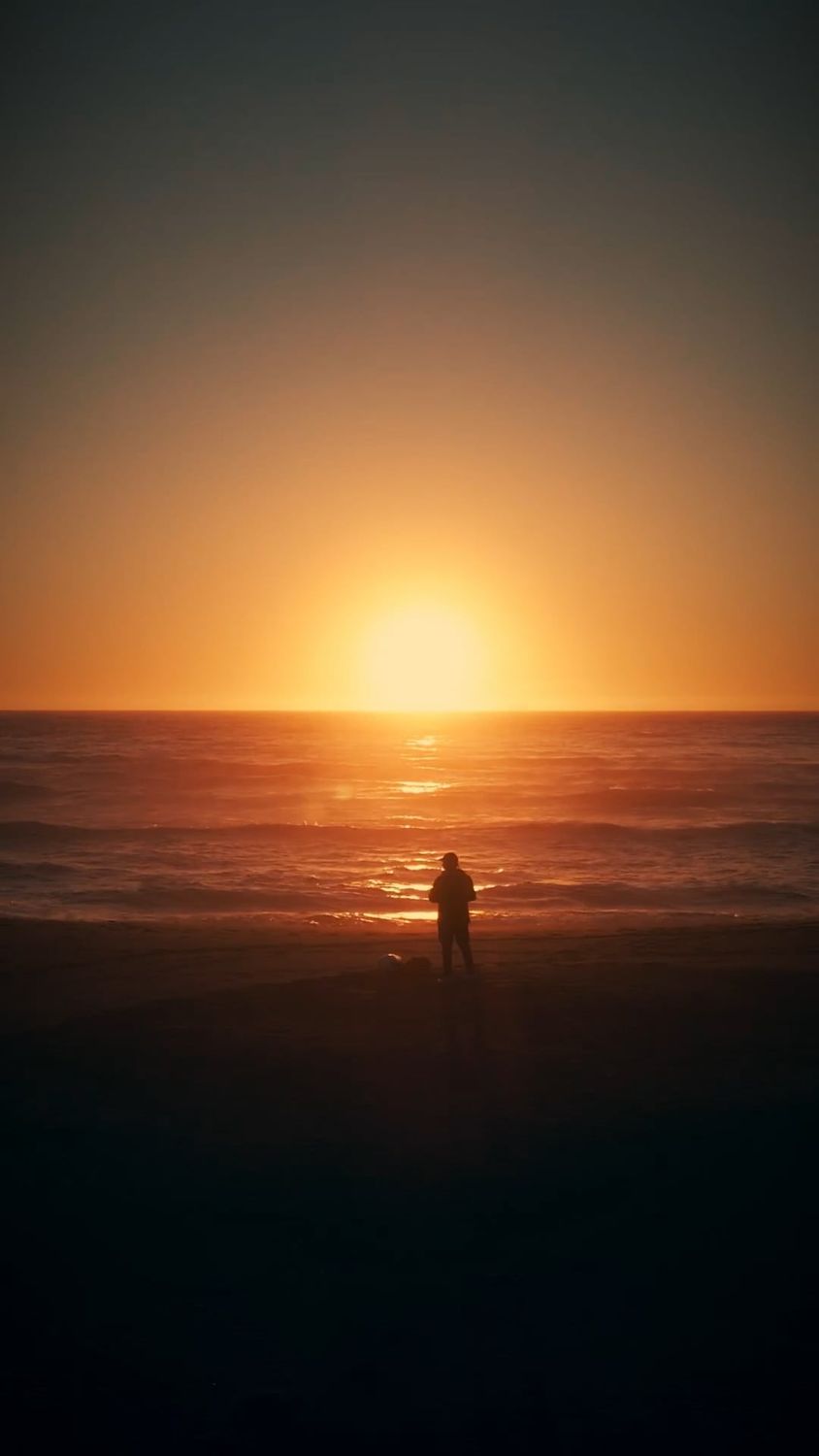 A person standing on the beach at sunset Free Stock Video Footage ...