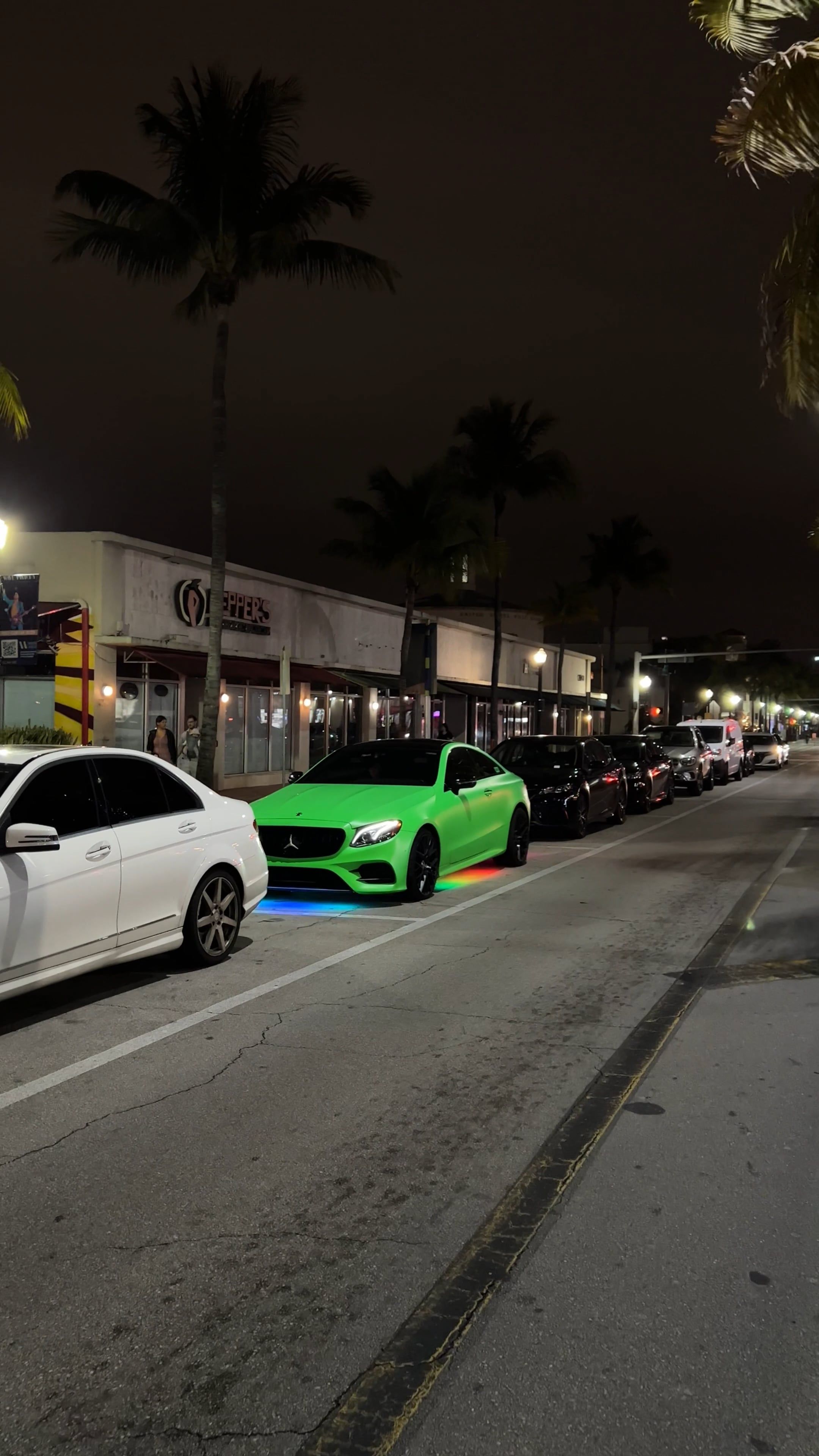 A green car parked on the street at night Free Stock Video Footage ...