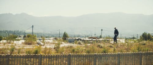 Person walking in front of a township rural area in South africa