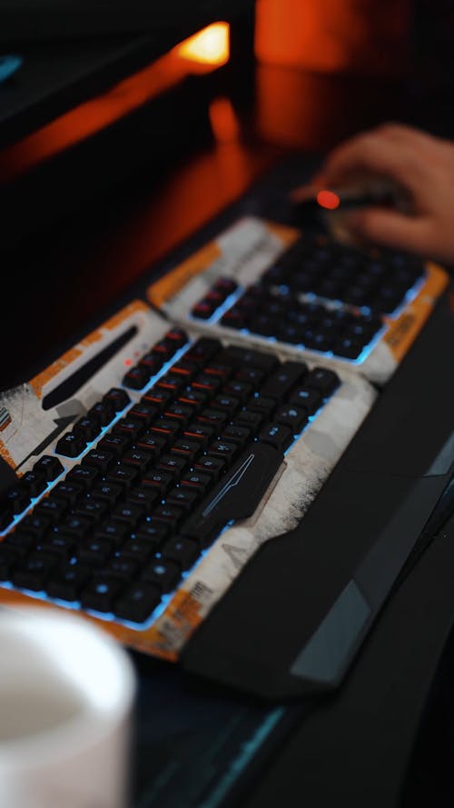 A Person Typing on a Gaming Keyboard 
