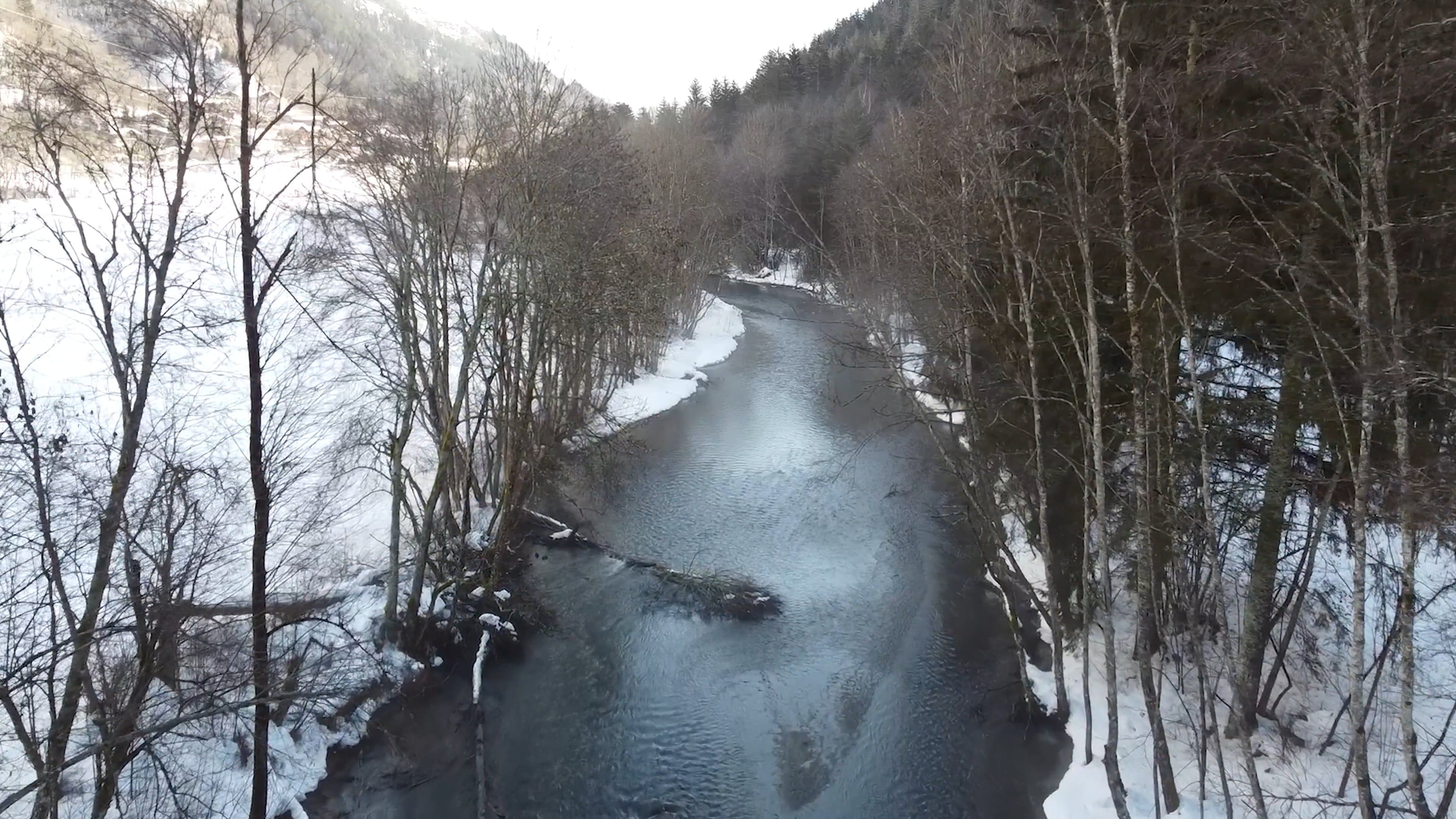 A river is flowing through the snow covered forest Free Stock Video ...