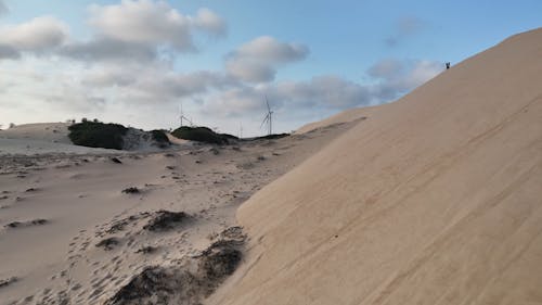 Drone Footage of Sand Dunes and Wind Turbines  