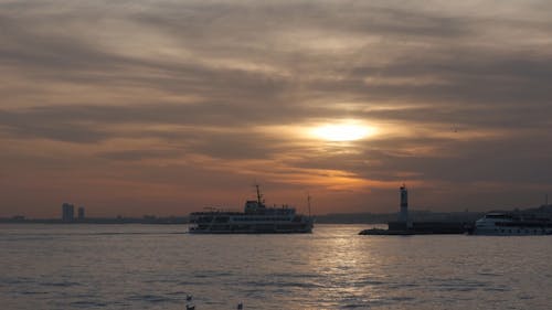 Ferry Boats in a Harbour at Sunset 