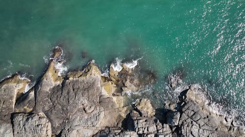 Top View of Turquoise Sea Water and a Rocky Shore 
