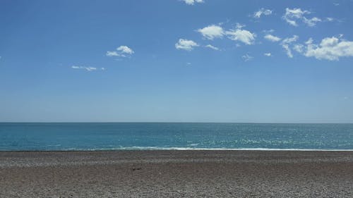 An Empty Beach under a Clear Blue Sky