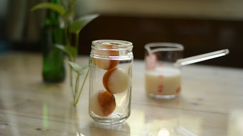 A Person Preparing a Glass of Iced Latte