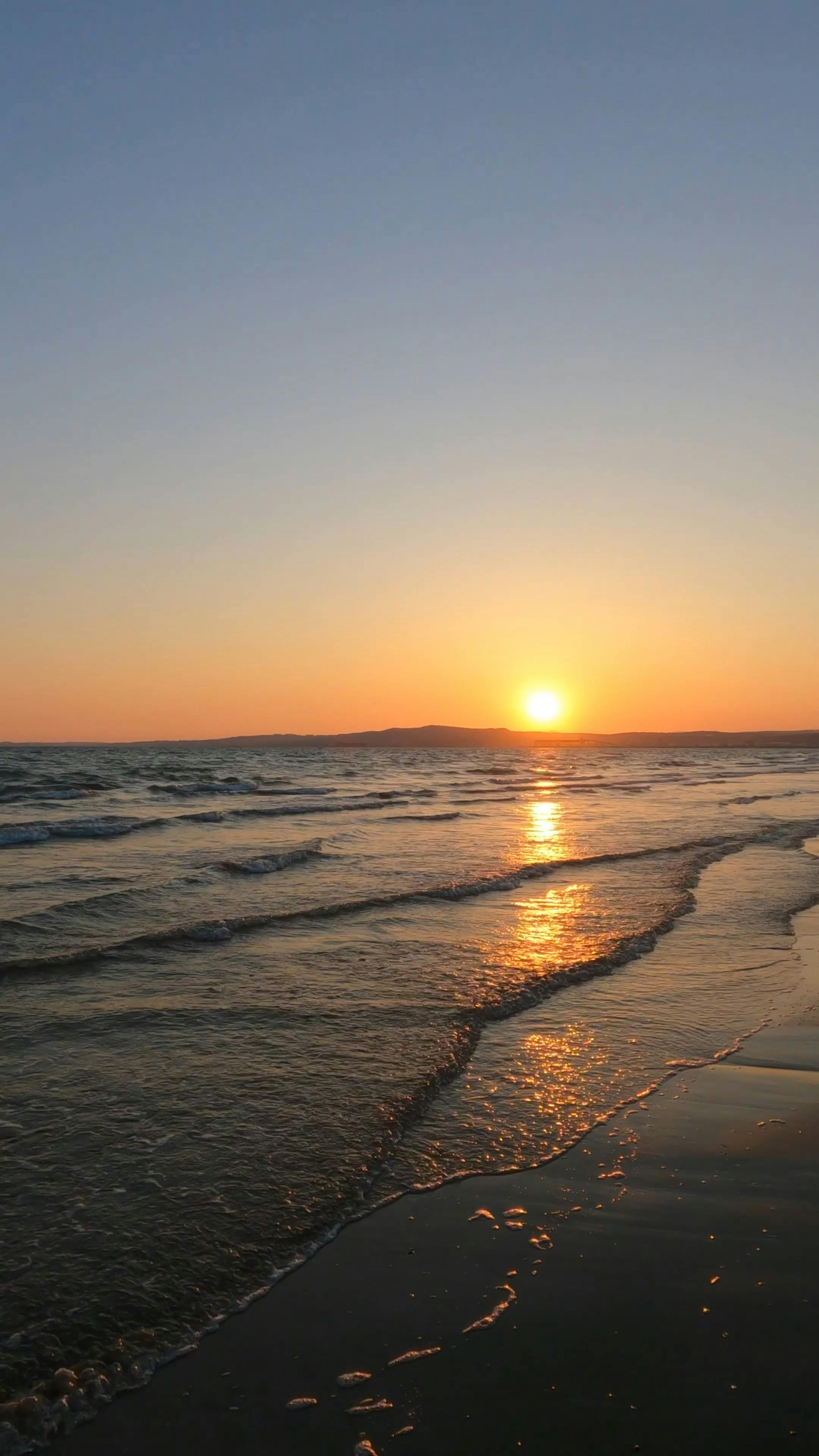 the sun is setting over the ocean in this photo 16650621