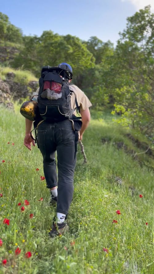 Back View of a Man Walking on a Mountain Trail