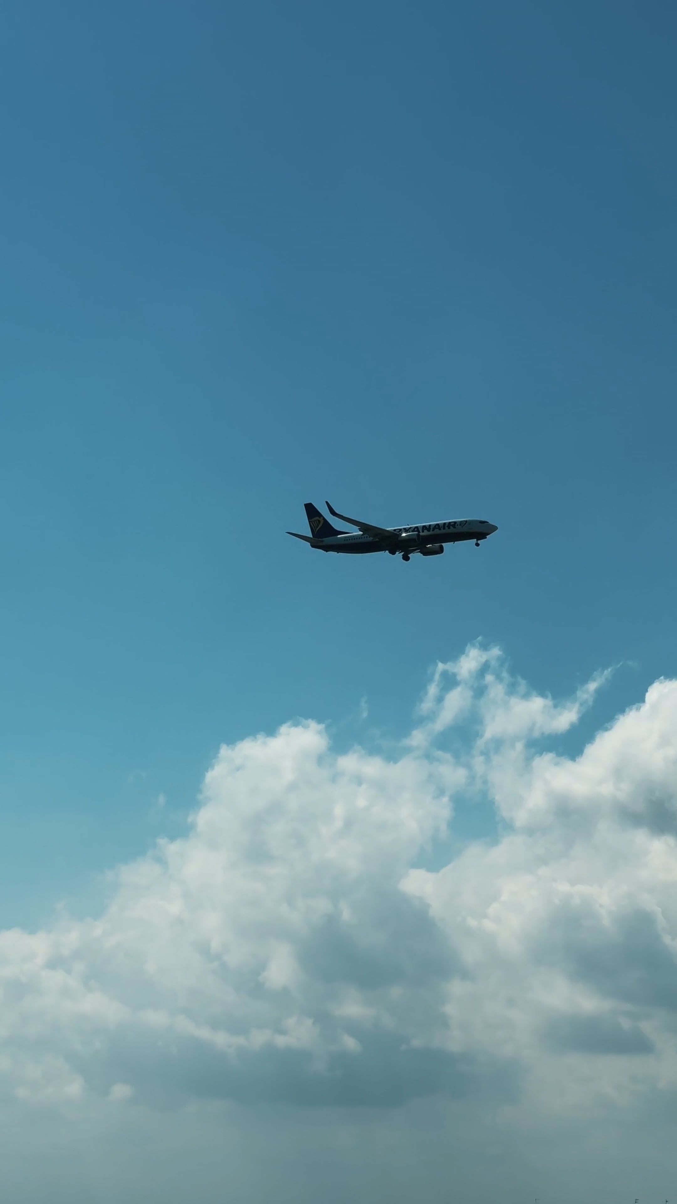A plane flying over a blue sky and a building Free Stock Video Footage ...