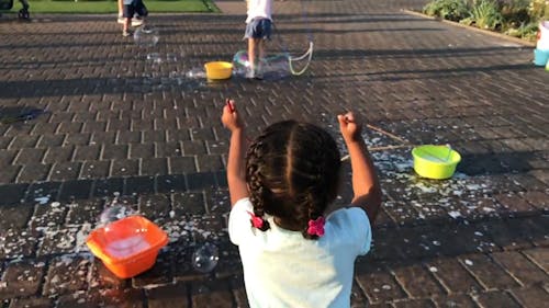 Girl Playing With Bubbles
