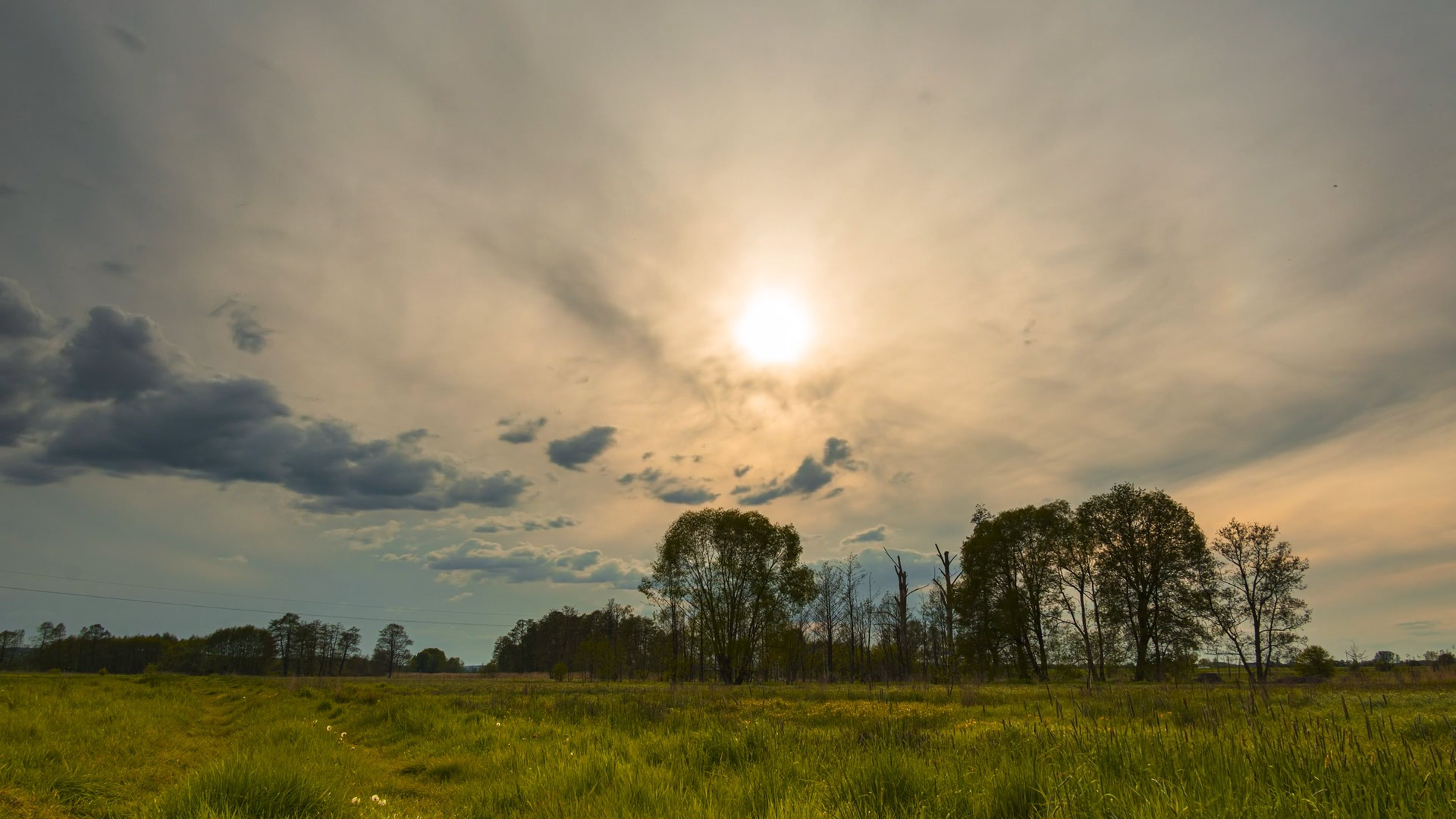 The sun shines through the clouds over a field Free Stock Video Footage ...