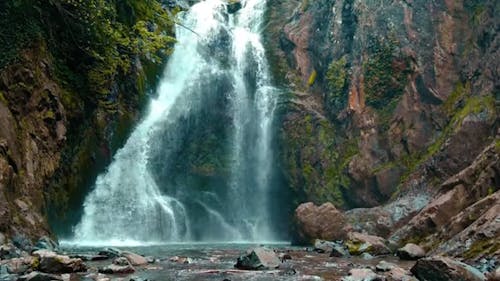 A Waterfall and Mossy Rock Formations 