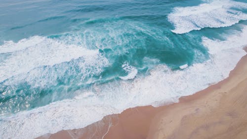 Drone view at  blue waves in Atlantic Ocean beach