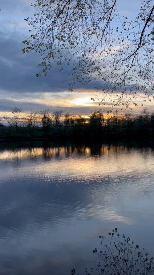 A Body of Water under a Sunset Sky 