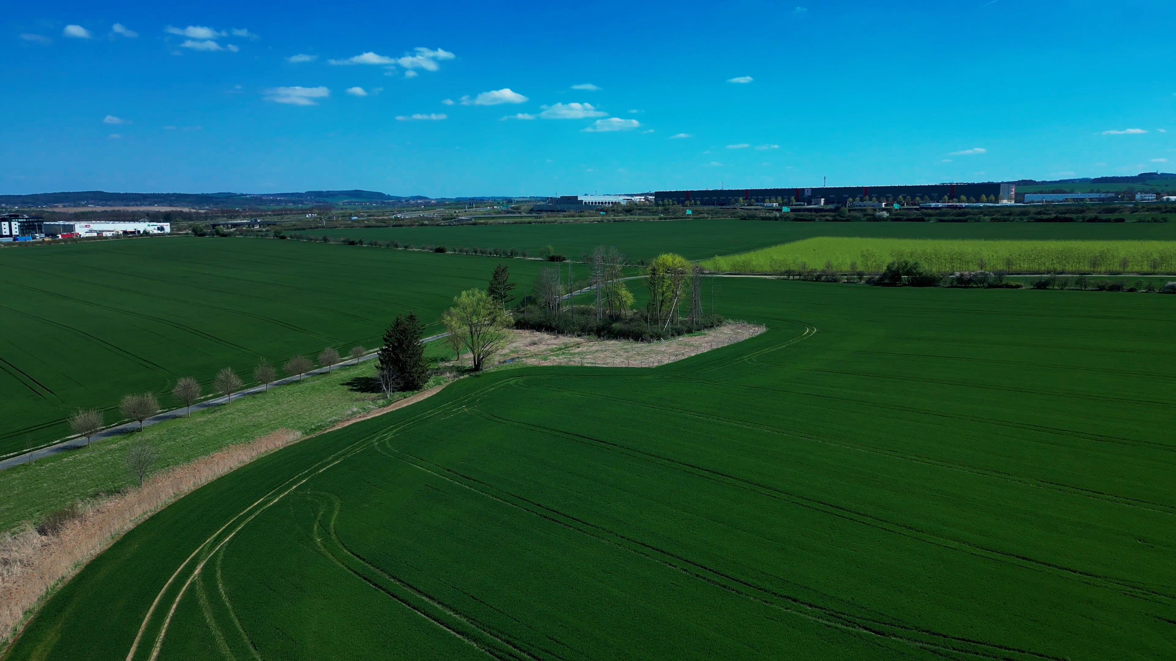 An aerial view of a field with trees and grass Free Stock Video Footage ...