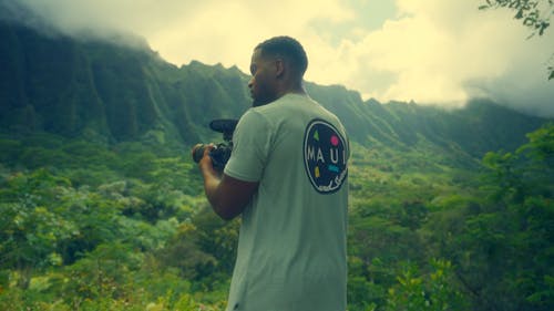 A Man Filming a Video in a Mountain Landscape in Hawaii 
