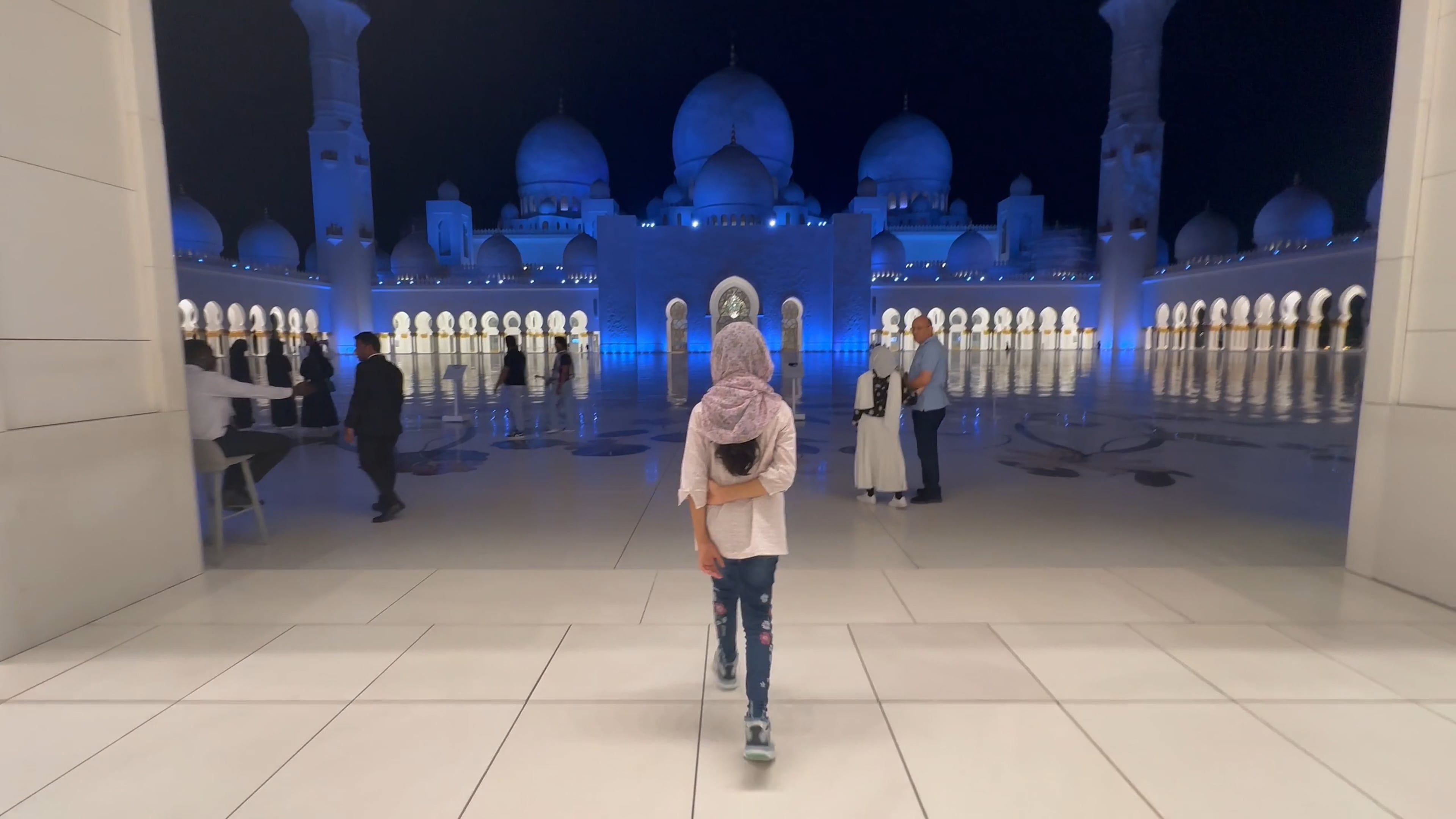 A girl walking in front of a large mosque Free Stock Video Footage ...