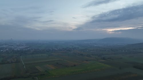 Drone Footage of Green Fields near the City 