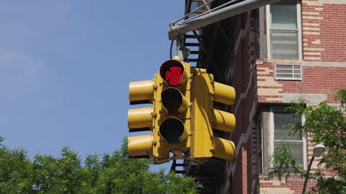 Yellow painted red stop light for three way intersection turns to a green light