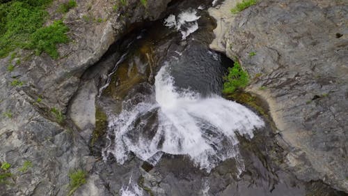 Aerial View of a Waterfall and Rock Formations 
