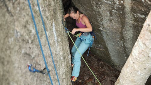 A Young Woman Scrapes her Back while Rock Climbing
