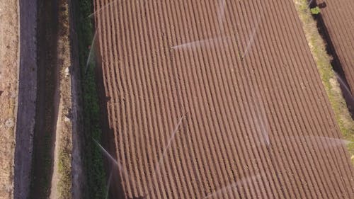 Aerial View of Irrigation on a Farm Field 