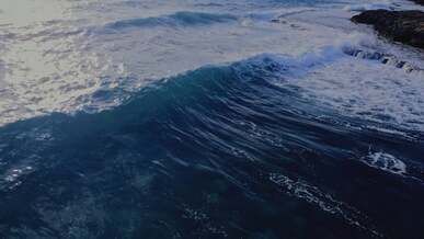 aerial view of a wave breaking on the shore