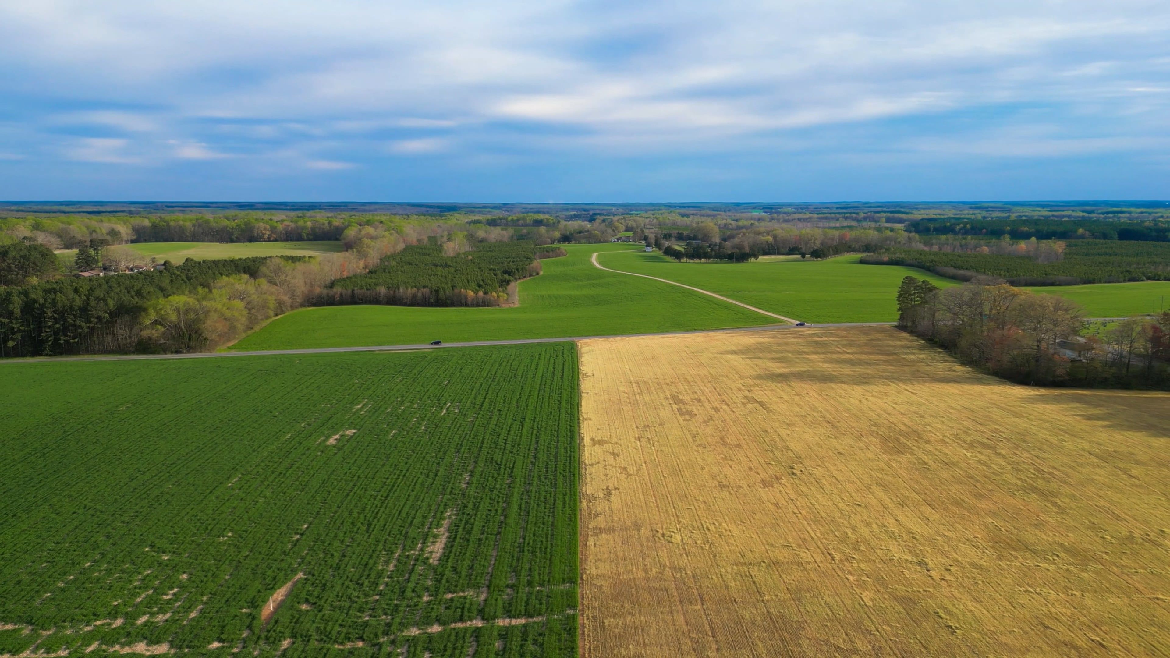 An aerial view of a farm with a large field and a small field Free ...