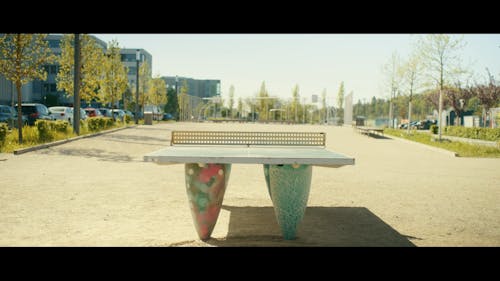 Table Tennis court with a basketball court next to office buildings in the city