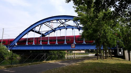 High Speed Train Passes Over an Arched Bridge
