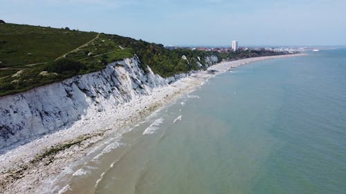 A Rocky Beach and Green Hills on the Coast of Eastbourne, England