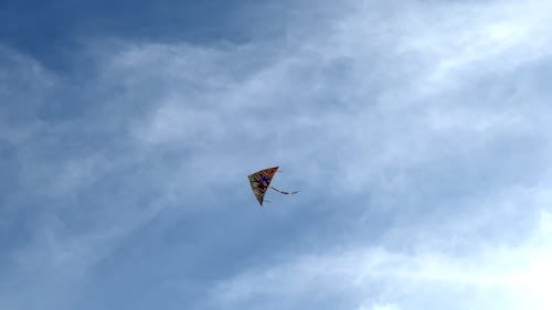 Low Angle View of a Colorful Kite Flying in the Sky