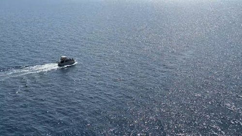 Drone View of a Small Yacht on Calm Sea Waters 