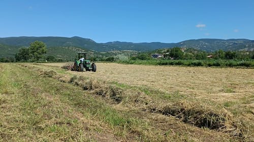 A Farmer Plowing a Field with a Tractor 